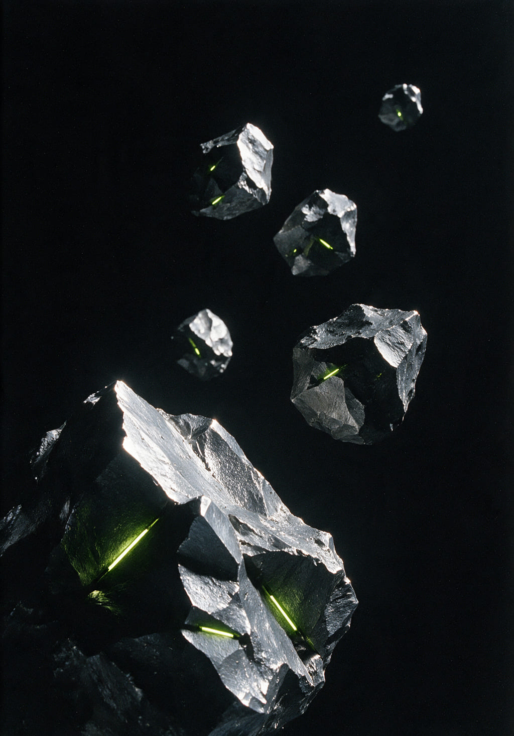 Six jagged asteroids drifting in black vacuum, lit hard from one side