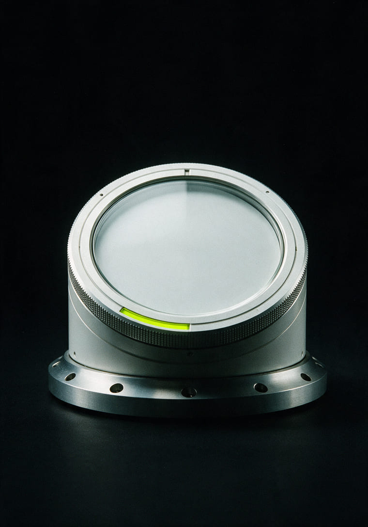 A machined mechanical timer with a blank dial and a knurled bezel, on black
